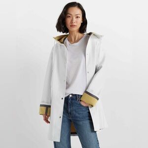 Club Monaco bonded-seam white raincoat with contrasting inverted cuffs